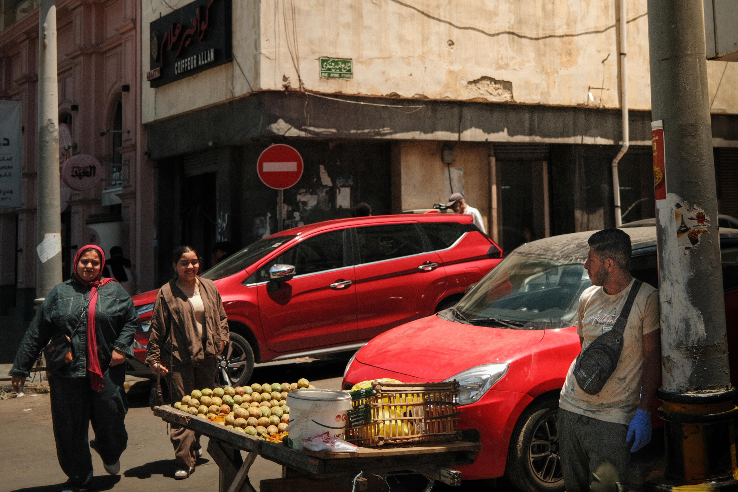 A pure street moment in Alexandria’s ancient streets. A very common scene of a prickly pear seller positioning himself at the beginning of a street for maximum visibility, while passersby are mingling around.