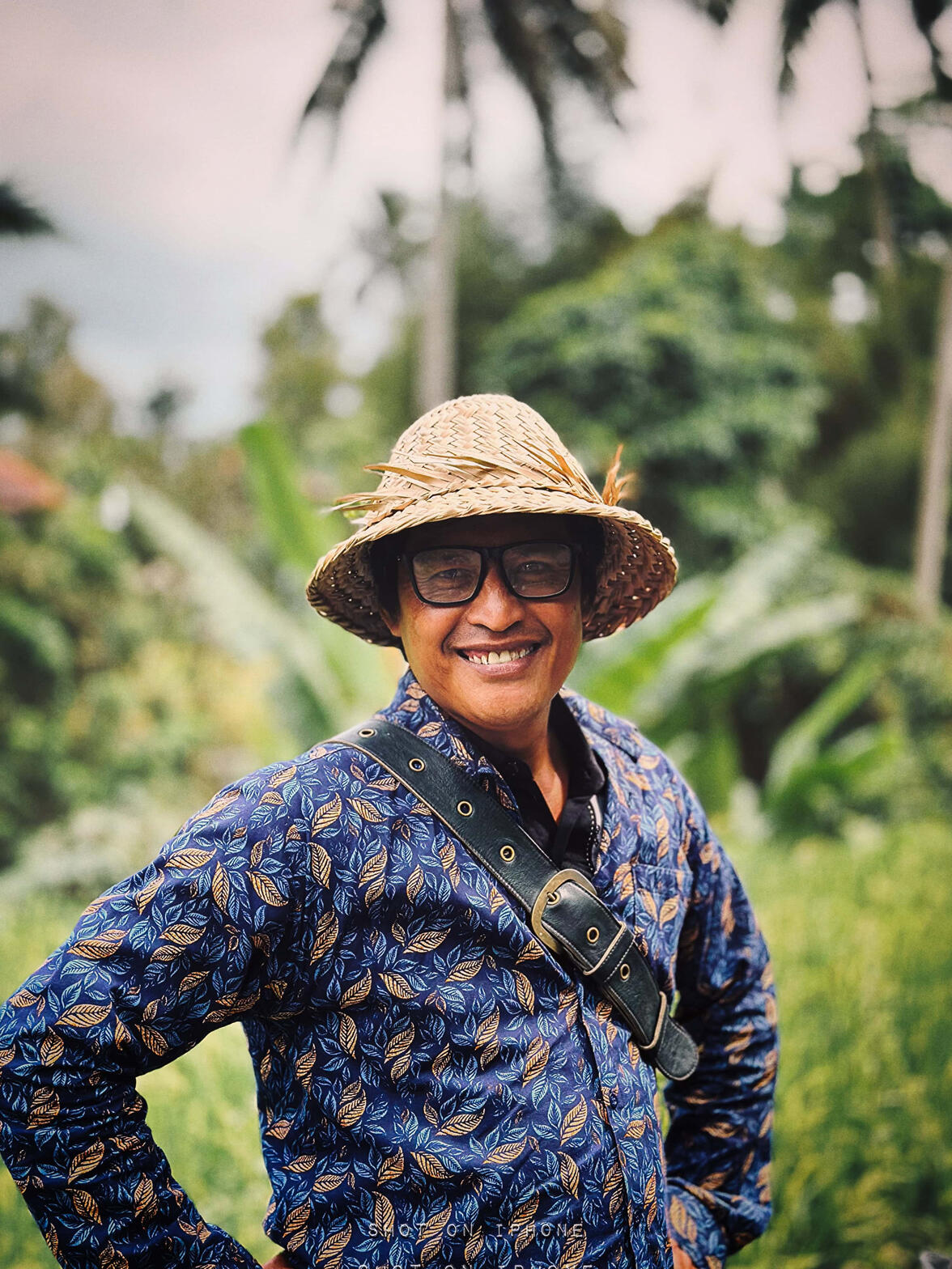 Bali's Rice Field — A candid moment with a farmer who looks after farming a rice field in total joy. A moment of joy that holds a lot of tiredness and life challenges; however, the posture remains positive and bright.