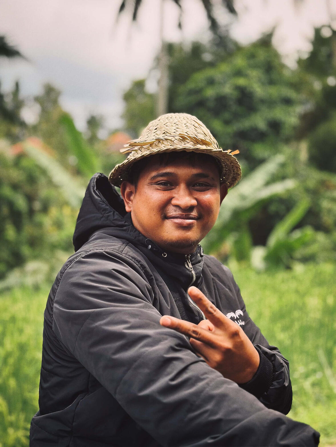 Bali's Rice Field — A candid moment with a farmer who looks after farming a rice field in total joy. A moment of joy that holds a lot of tiredness and life challenges; however, the posture remains positive and bright.